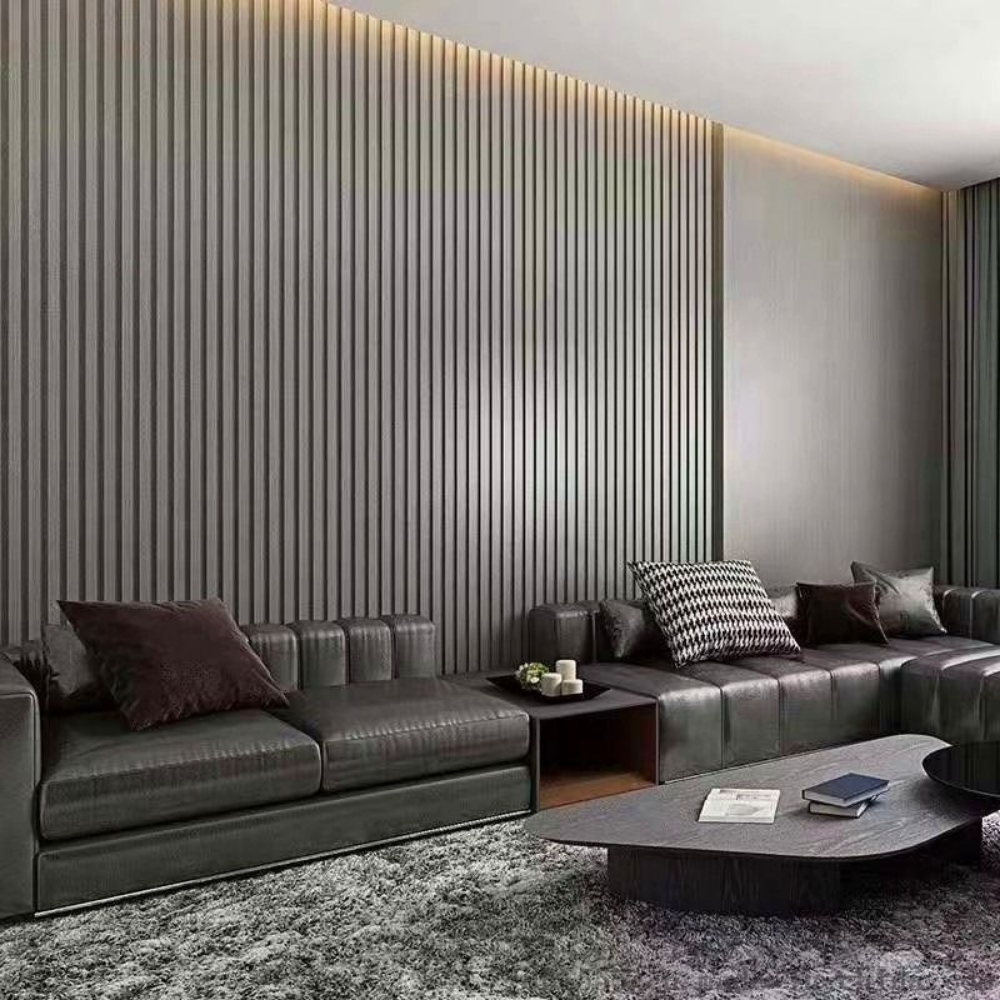 Dark grey vertical aluminum panels on an interior feature wall with warm recessed lighting